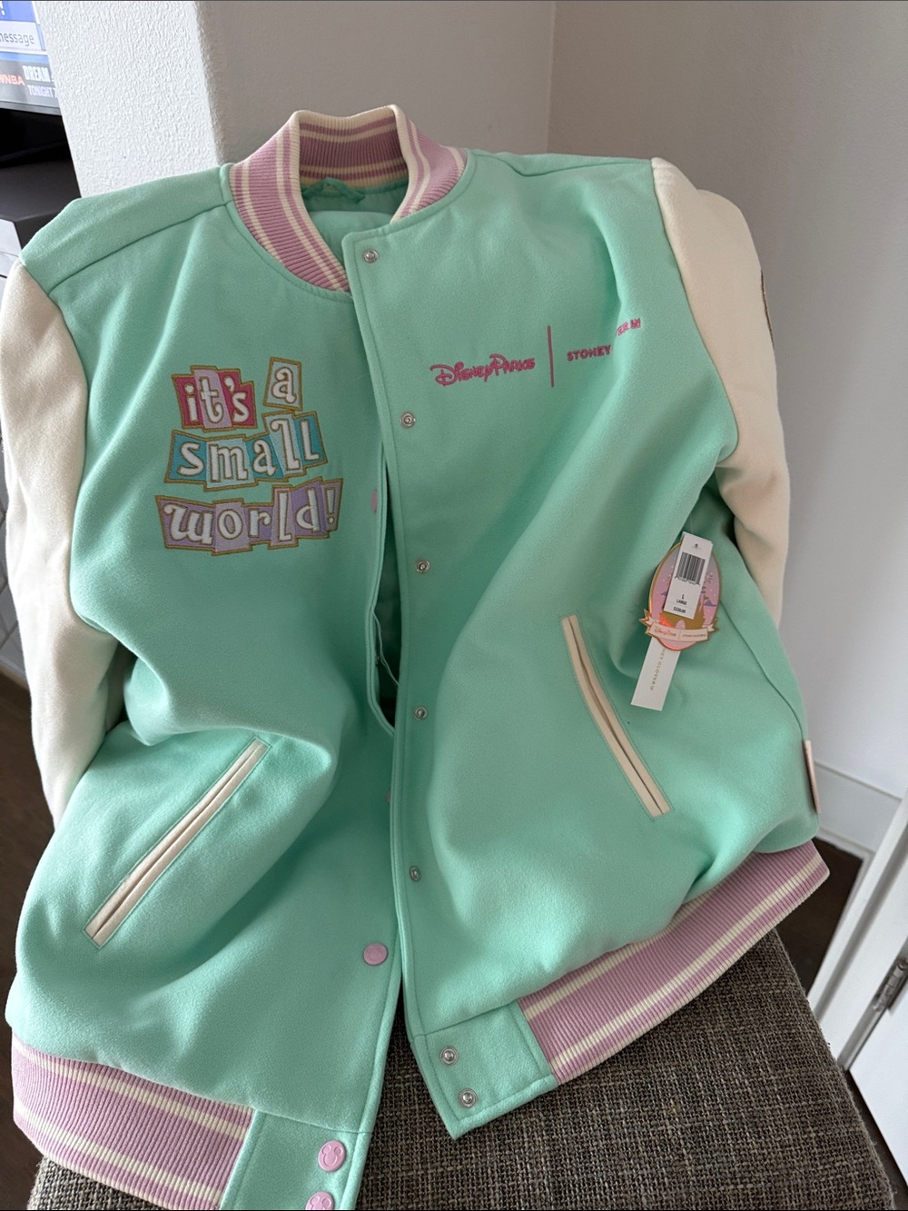 Disney Mint Green & Cream 'It's a Small World' Varsity Jacket with Pink Trim